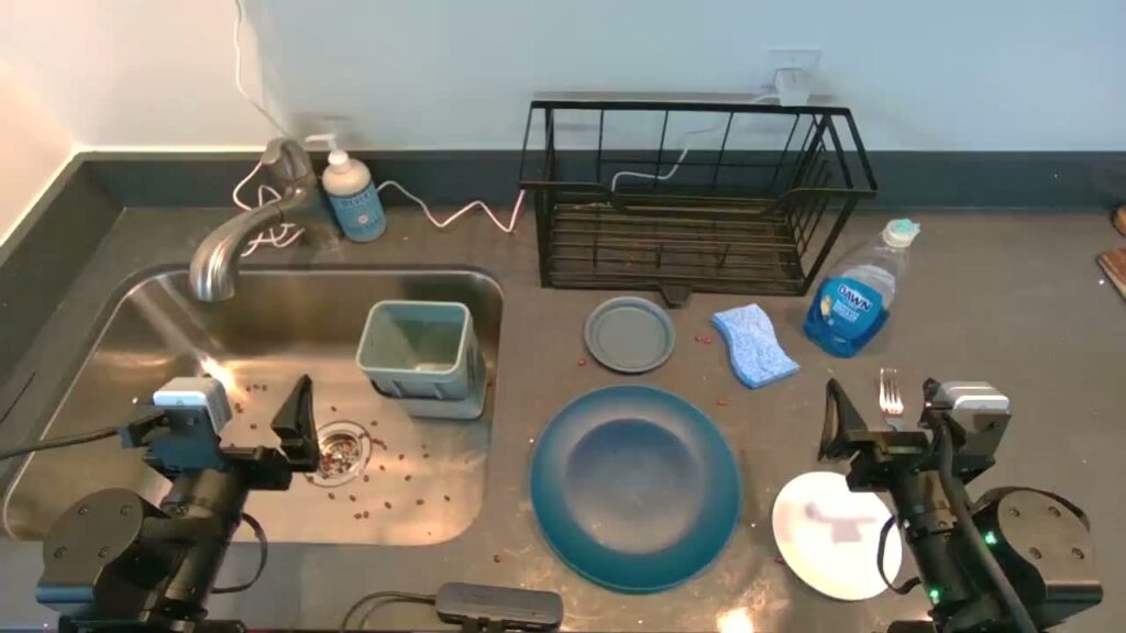 Two robot arms run by Dream-1 at a sink with dishes (Dream Labs)
