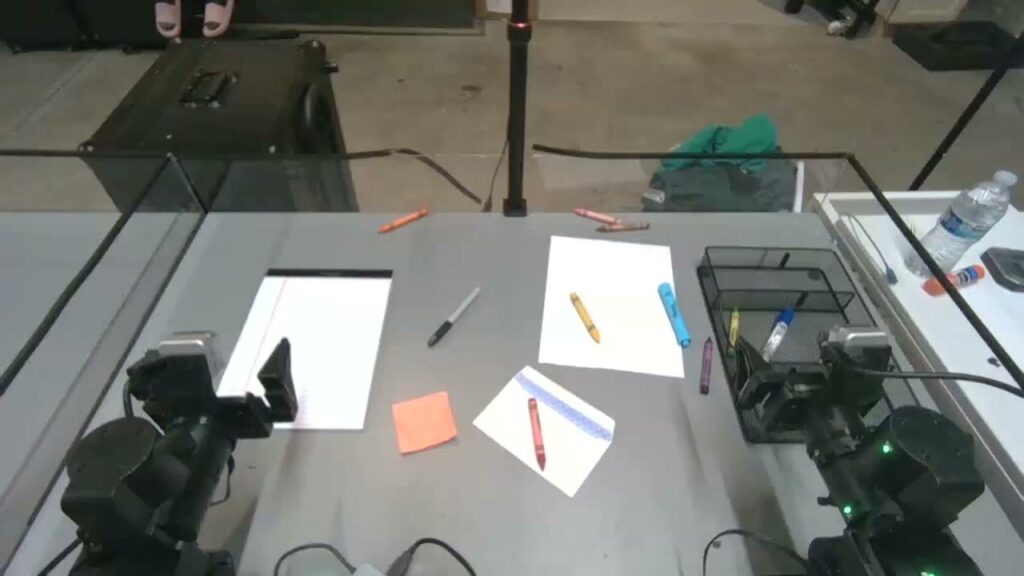 Dream-1 tidying papers and pens on a desk (Dream Labs)