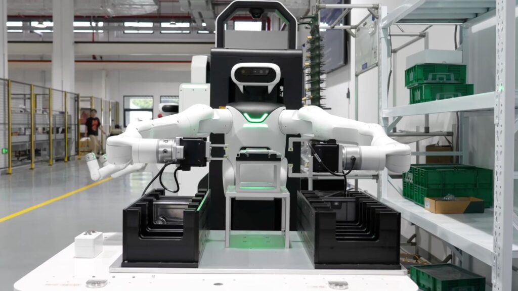 JAKA wheeled humanoid at a factory workstation