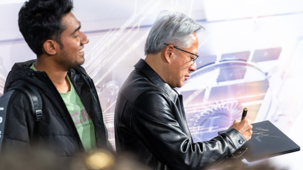 Jensen Huang signs an RTX Spark laptop at the Berlin launch event (NVIDIA)