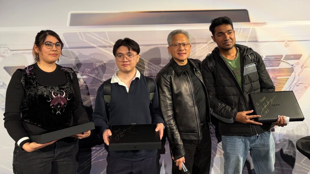 Jensen Huang with fans holding signed RTX Spark laptops in Berlin (NVIDIA)
