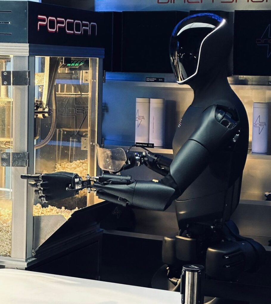 Optimus serving popcorn, one of the jobs Tesla has shown it doing (Tesla)